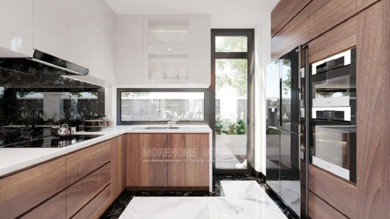 Là một trong những xu hướng trang trí nội thất ấn tượng trong những năm tới, bố trí phòng bếp hiện đại tôn lên vẻ đẹp mộc mạc nhưng không kém phần sang trọng của gỗ điển hình là gỗ óc chó tự nhiên. Loại gỗ rất được ưa chuộng trong các siêu xe bởi vẻ đẹp ấn tượng từ vân, màu gỗ. Như trong ý tưởng bố trí phòng bếp tại biệt thự Vinhomes Imperia, sự hài hòa tôn lên nét đẹp giữa truyền thống và hiện đại, tủ bếp dưới gỗ óc chó và tủ bếp trên gỗ công nghiệp trắng bóng. Mẫu tủ bếp biệt thự acrylic