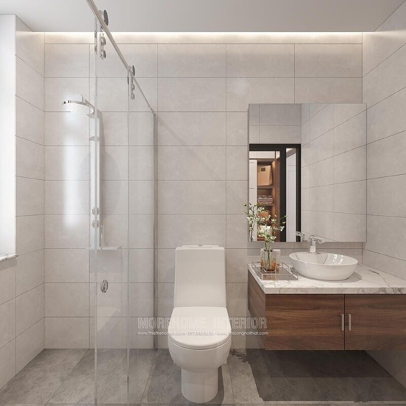 Thiết kế phòng tắm chung cư theo phong cách hiện đại với các đồ vật tinh giản nhưng lại tạo nên vẻ đẹp sang trọng bằng cách sử dụng các loại ốp gạch giả bê tông, gương không khung và cửa trượt kính trong phòng tắm.